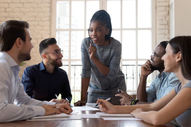 Leader with her team at a conference table