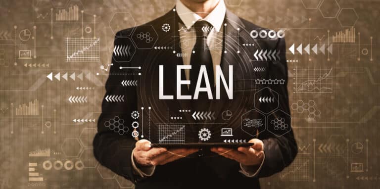 Man in a suit holding a tablet projecting the word "Lean."